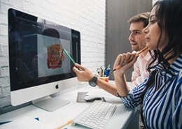 A Guide to Hiring a Professional Graphic Designer for Your Business 4 professional graphic designer discussing artwork on computer
