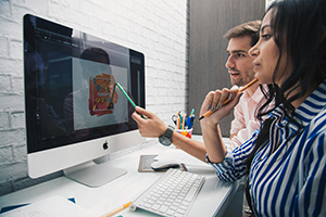 professional graphic designer discussing artwork on computer