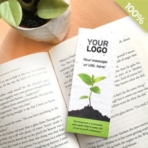 A bookmark with embedded seeds, sprouting tiny green shoots