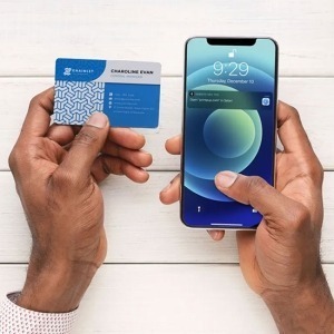 A NFC business card being scanned, revealing contact info on a phone screen