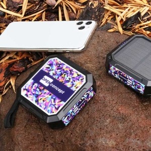 A compact solar power bank unfolded under sunlight, charging a device